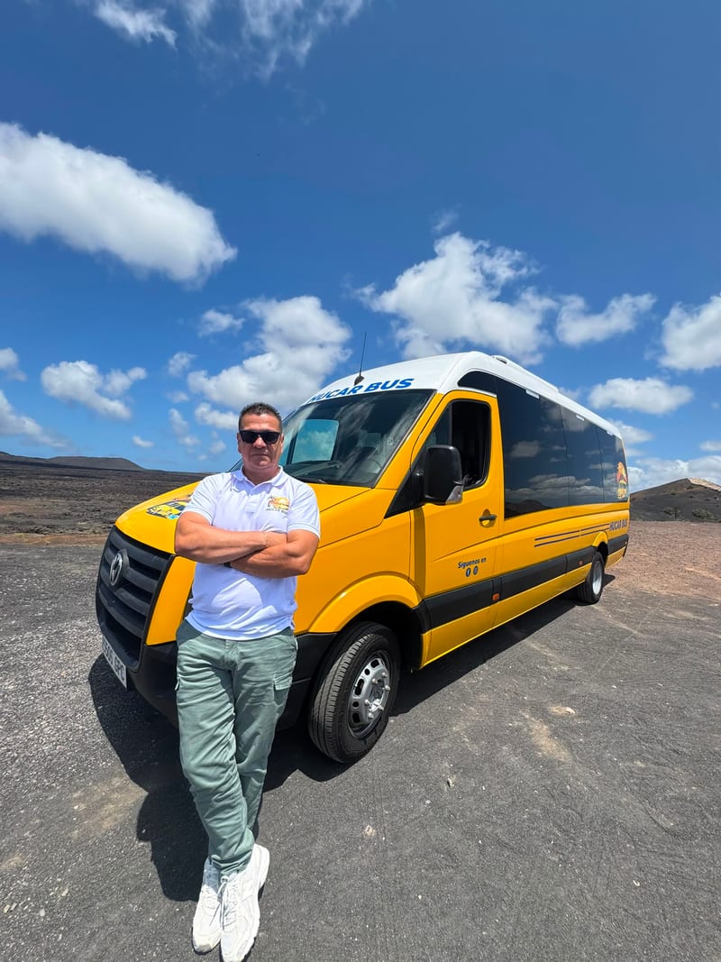 A Hucar Bus driver beside one of the company minibuses in Lanzarote
